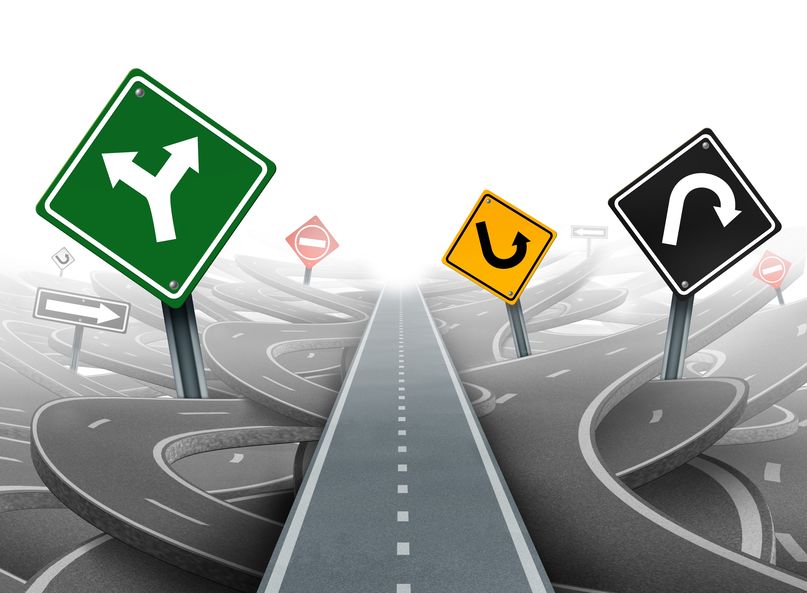 Avoiding distractions and clear strategy for solutions in business leadership with a straight path to success choosing the right strategic plan with yellow green black and red traffic signs through a maze of highways